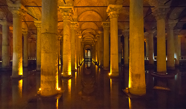 a long hallway with columns and lights in it a long hallway with columns and lights in it